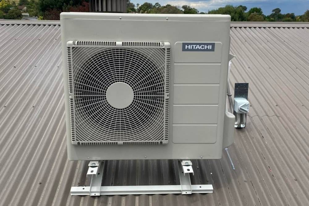 Hitachi air conditioning unit mounted on a metal roof